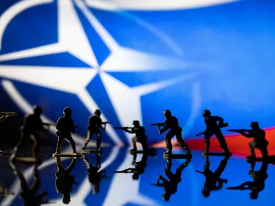 FILE PHOTO: Army soldier figurines are displayed in front of the NATO logo and Russian flag colours background in this illustration taken, February 13, 2022. REUTERS/Dado Ruvic/Illustration/File Photo