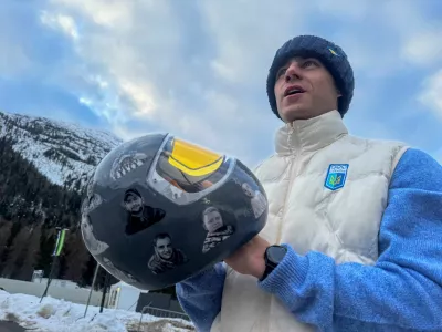 Ukrainian skeleton athlete Vladyslav Heraskevych holds his helmet with images of compatriots killed during the war in Ukraine, at the Milano Cortina Gamesin in Cortina D'Ampezzo, Italy, February 9, 2026. REUTERS/Cristiano Corvino