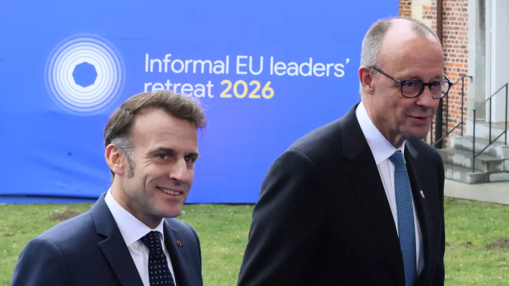 French President Emmanuel Macron, left, and Germany's Chancellor Friedrich Merz arrive for the EU summit at Alden Biesen Castle in Bilzen-Hoeselt, Belgium, Thursday, Feb. 12, 2026. (AP Photo/Francois Walschaerts)