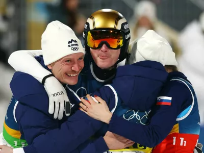 Milano Cortina 2026 Olympics - Ski Jumping - Mixed Team - Predazzo Ski Jumping Stadium, Predazzo, Italy - February 10, 2026. Nika Vodan of Slovenia, Anze Lanisek of Slovenia, Domen Prevc of Slovenia and Nika Prevc of Slovenia celebrate winning the gold medal after the final round. REUTERS/Kai Pfaffenbach