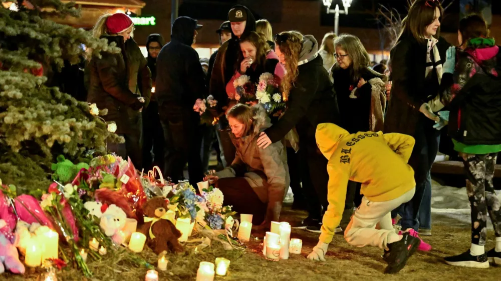 People react during a vigil, the day after a deadly mass shooting took place, in the town of Tumbler Ridge, British Columbia, Canada February 11, 2026. REUTERS/Jennifer Gauthier REFILE - FIXING TYPO IN LOCATION