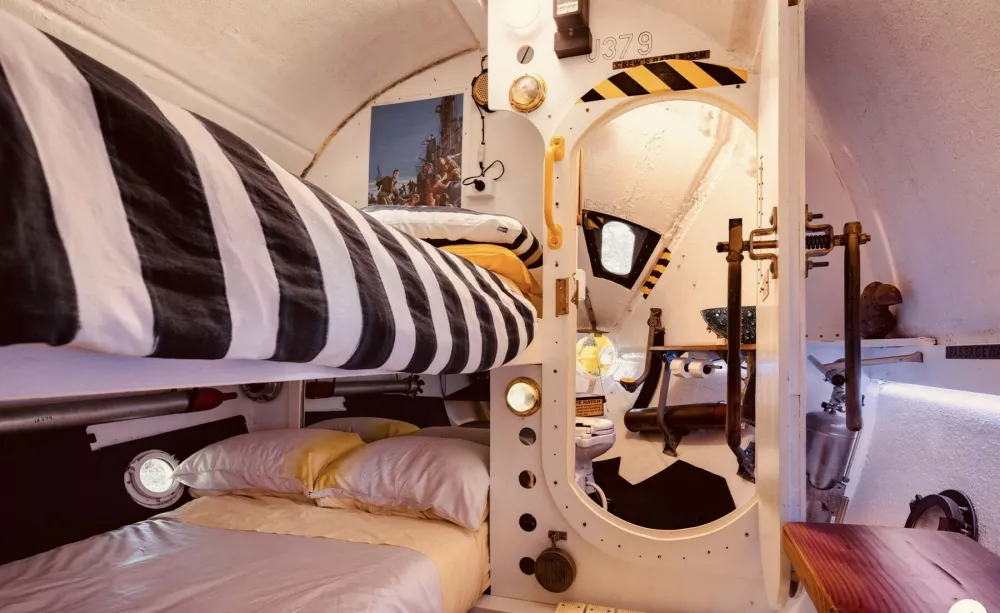 Inside the Beatles-themed Yellow Submarine Airbnb. // A couple have built a Beatles-themed Yellow Submarine Airbnb - and even John Lennon's family have come to stay. Keith Lovelock and his wife Jen built the submarine - and turned it into one of the quirkiest holiday stays 's in the world. The whole rental is dotted with references to nautical travel and the Beatles -and even comes with a John Lennon-inspired mannequin. The accommodation in Marton, Manawatu-Wanganui, New Zealand is deemed by Airbnb as one of the quirkiest places to stay. Photo released 11/01/2026,Image: 1065229157, License: Rights-managed, Restrictions: Editorial use, commercial use may require additional licenses. We don't use AI to make images which could be mistaken for news photos. AI use will be clearly indicated. Supplied on condition you ensure personal data is processed in compliance with UK GDPR, Model Release: no