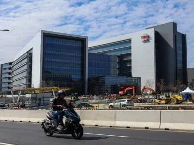 A man rides past an under-construction fabrication plant of 2-nanometer semiconductors for TSMC or Taiwan Semiconductor Manufacturing Corp., a Taiwanese multinational semiconductor contract manufacturing and design company, in Hsinchu, Taiwan, on Thursday, Jan. 29, 2026. (AP Photo/Daniel Ceng)