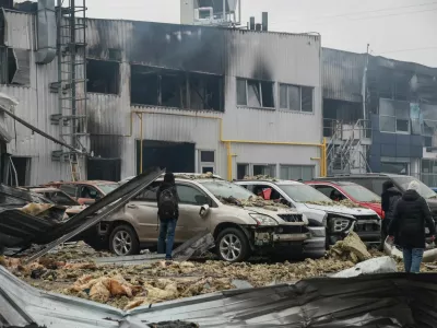 Residents inspect damaged cars at the site of a Russian drone strike, amid Russia's attack on Ukraine, in Odesa, Ukraine February 13, 2026. REUTERS/Nina Liashonok