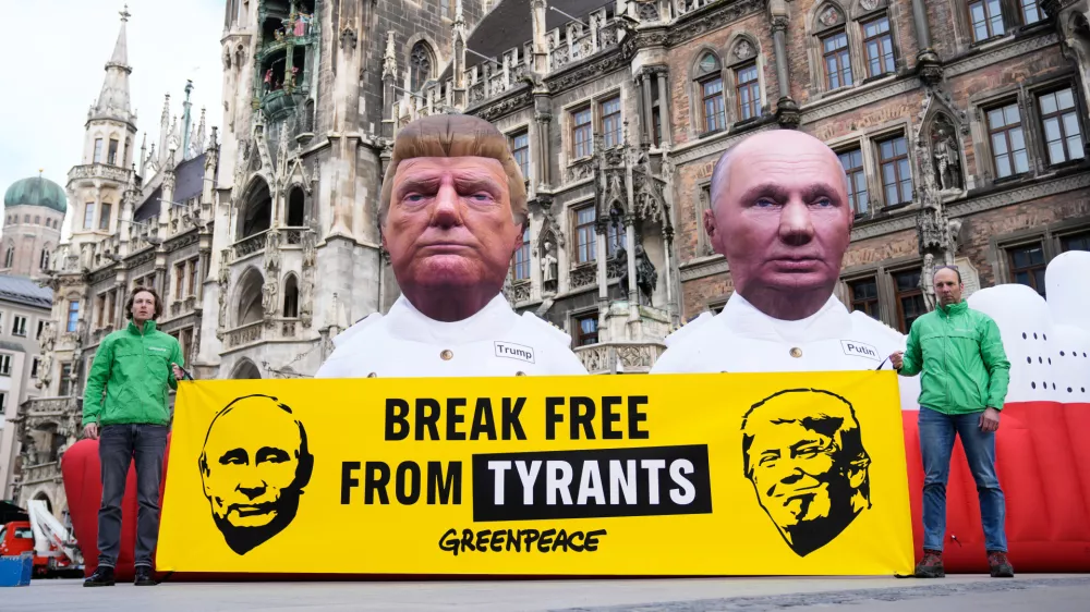 Figures depicting US President Donald Trump and Russian President Vladimir Putin, right, are displayed at Marienplatz square, as part of a protest against fossil energy by the environment organisation Greenpeace during the Munich Security Conference in Munich, Germany, Friday, Feb. 13, 2026. (AP Photo/Ebrahim Noroozi)