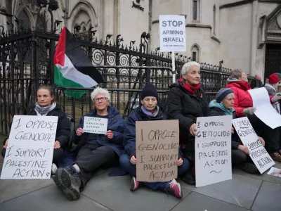 Supporters of Palestine Action stage a protest outside the Royal Court of Justice in London, Friday, Feb. 13, 2026. (AP Photo/Kin Cheung)