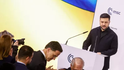 NATO Secretary General Mark Rutte and the chairman of the Munich Security Conference Wolfgang Ischinger in front of Ukrainian President Volodymyr Zelenskiy as he delivers a speech during the Munich Security Conference (MSC) in Munich, Germany, February 14, 2026. REUTERS/Liesa Johannssen