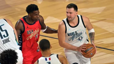 Feb 15, 2026; Inglewood, California, USA; Team World guard Luka Doncic (77) of the Los Angeles Lakers controls the ball against Team USA Stars guard Anthony Edwards (5) of the Minnesota Timberwolves in game one during the 75th NBA All Star Game at Intuit Dome. Mandatory Credit: Jayne Kamin-Oncea-Imagn Images