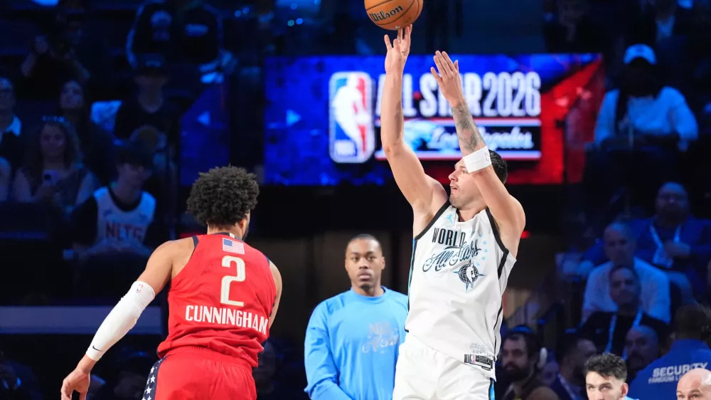 World forward Luka Dončić, of Slovenia, shoots over USA Stars guard Cade Cunningham (2) during the NBA All-Star basketball game Sunday, Feb. 15, 2026, in Inglewood, Calif. (AP Photo/Mark J. Terrill)