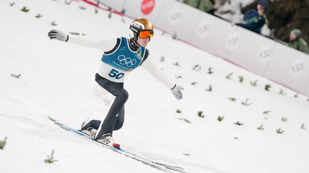 Domen Prevc, of Slovenia, lands his first round jump of the ski jumping men's large hill individual at the 2026 Winter Olympics, in Predazzo, Italy, Saturday, Feb. 14, 2026. (AP Photo/Kirsty Wigglesworth)