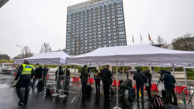 Journalists gather outside the entrance of the Intercontinental Hotel where U.S., Ukraine and Russia are meeting to discuss peace plan, in Geneva, Switzerland, Wednesday, Feb. 18, 2026. (Martial Trezzini/Keystone via AP)