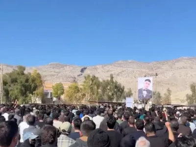 People stand facing the portrait of a deceased person as they gather at a cemetery in Abdanan, Ilam Province, Iran, in this screengrab taken from a social media video released February 17, 2026. Social media via RUTERS THIS IMAGE HAS BEEN SUPPLIED BY A THIRD PARTY. NO RESALES. NO ARCHIVES