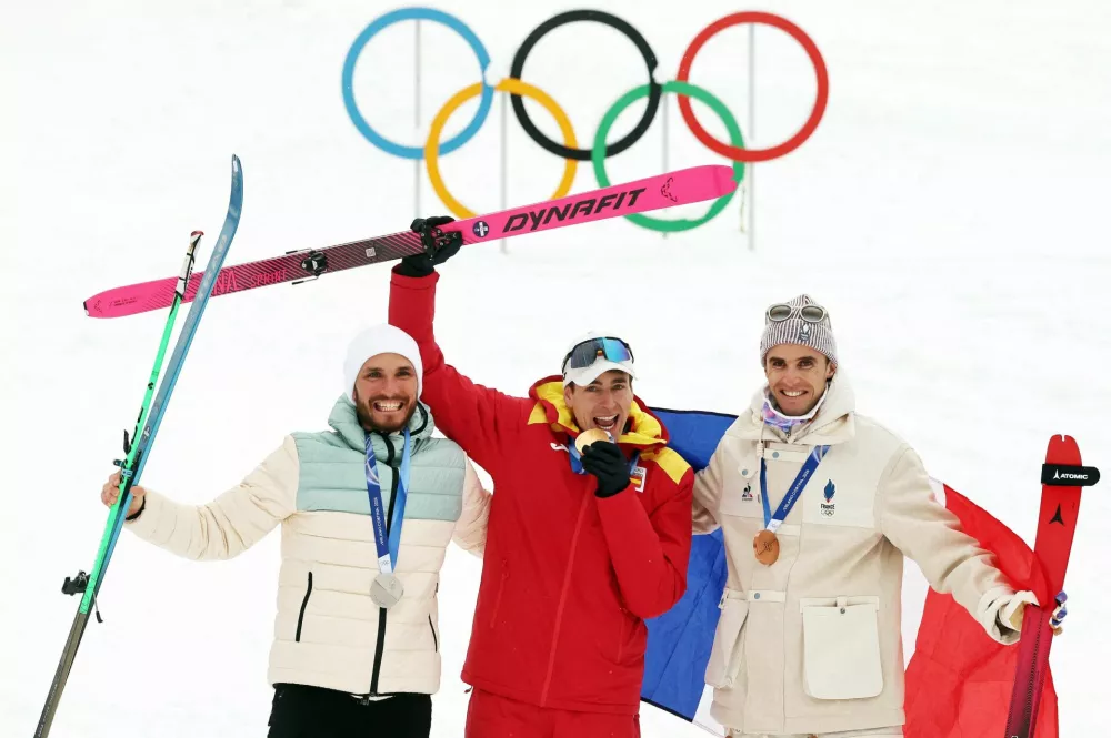 Milano Cortina 2026 Olympics - Ski Mountaineering - Men's Sprint Victory Ceremony - Stelvio Ski Centre, Bormio, Italy - February 19, 2026. Gold medallist Oriol Cardona Coll of Spain celebrates after winning the Ski Mountaineering - Men's Sprint with silver medallist Nikita Filippov of AIN (Individual Neutral Athletes) and bronze medallist Thibault Anselmet of France REUTERS/Christian Hartmann   TPX IMAGES OF THE DAY