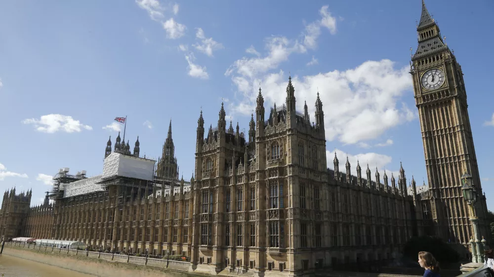 General view of the Houses of Parliament with scaffolding erected around a section of it in London, Thursday, Sept. 8, 2016. A committee charged with stopping Britain's creaky, leaky Parliament from falling down is set to say whether lawmakers will have to move out for several years so repair work can be done. The Joint Committee on the Palace of Westminster has been studying options for the 19th-century complex, which needs work to repair collapsing roofs, crumbling walls and leaking pipes, and to remove asbestos. (AP Photo/Frank Augstein)