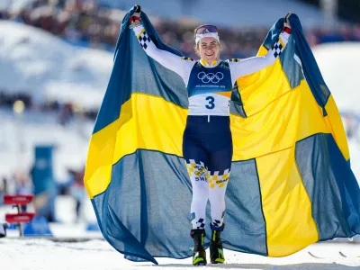Ebba Andersson, of Sweden, celebrates after winning the gold medal in the cross country skiing women's 50km mass start classic at the 2026 Winter Olympics, in Tesero, Italy, Sunday, Feb. 22, 2026. (AP Photo/Matthias Schrader)