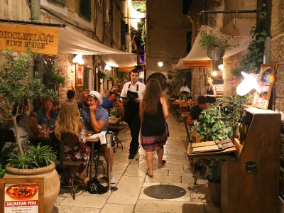Pedestrians and customers enjoying the restaurants and nightlife of Split in Croatia