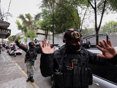 National Guards remove pedestrians by the General Prosecutor's headquarters in Mexico City, Sunday, Feb. 22, 2026, after the death of the leader of the Jalisco New Generation Cartel, Nemesio Rub&eacute;n Oseguera Cervantes, known as "El Mencho." (AP Photo/Ginette Riquelme)