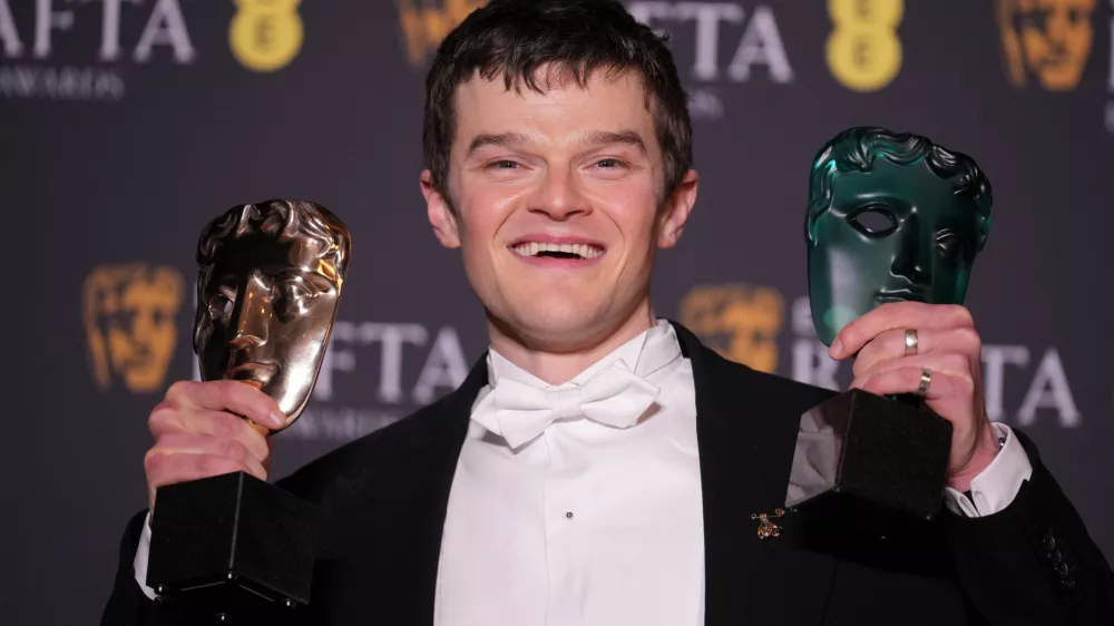 Robert Aramayo poses with the EE rising star award and the award for leading actor for 'I Swear' at the 79th British Academy Film Awards, BAFTA's, in London, Sunday, Feb. 22, 2026. (AP Photo/Alastair Grant)