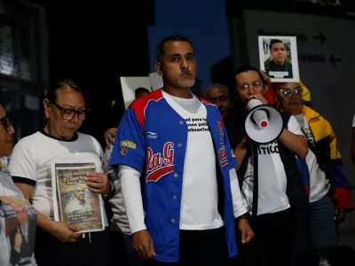 Opposition figure Juan Freites, center, stands with relatives of people they consider political prisoners, after his release from El Helicoide, an intelligence headquarters and detention center, in Caracas, Venezuela, Sunday, Feb. 22, 2026. (AP Photo/Cristian Hernandez)