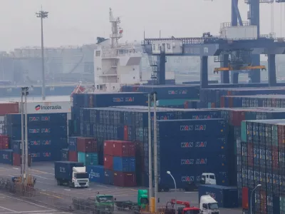 FILE PHOTO: FILE PHOTO: Trucks drive between cargo containers at Port of Taichung in Taichung, Taiwan April 18, 2023. REUTERS/Ann Wang/File Photo/File Photo