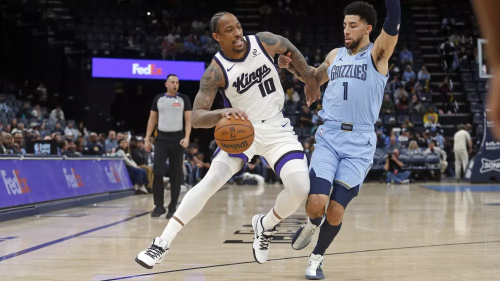 Feb 23, 2026; Memphis, Tennessee, USA; Sacramento Kings guard DeMar DeRozan (10) drives to the basket as Memphis Grizzlies guard Scotty Pippen Jr. (1) defends during the first quarter at FedExForum. Mandatory Credit: Petre Thomas-Imagn Images