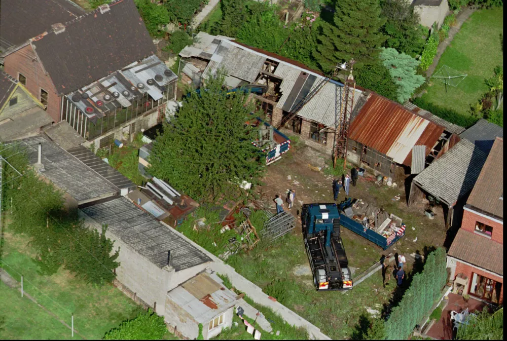 Photo made Aug.27, 1996. Aerial shot of the house, upper left, and backyard of Marc Dutroux, in Jumet near Charleroi, where police unearthed the remains of two people Tuesday Sept. 3, 1996 buried in one of the sheds in the back garden. Dutroux, who has been previously convicted as child rapist, is the key suspect still being investigated in the murder of at least two young girls. (AP PHOTO/Bernad Delentree)