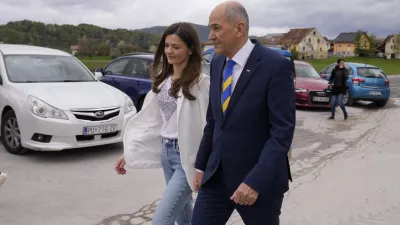 Slovenia's Prime Minister Janez Jansa with his wife Urska Bacovnik Jansa walks away from a polling station in Sentilj, Slovenia, Sunday, April 24, 2022. Slovenians cast ballots in a parliamentary election that is expected to be a tight race between Prime Minister Janez Jansa's ruling right-wing populists and liberals in the politically divided European Union nation. (AP Photo/Darko Bandic)