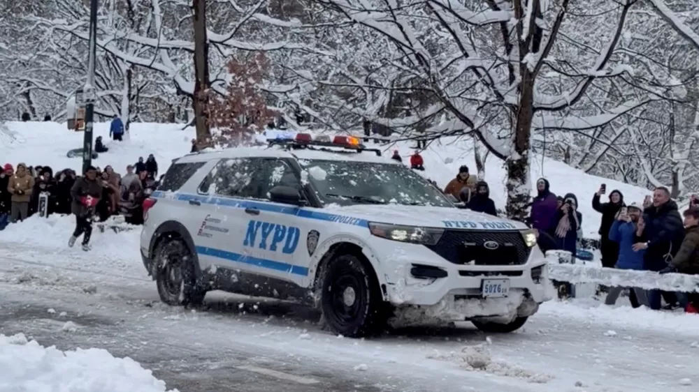 People throw snowballs at an NYPD vehicle in Central Park, as New Yorkers venture outside during a powerful winter storm that blanketed much of the U.S. Northeast, in New York, U.S., February 23, 2026, in this still image obtained from social media video. Maira Ahmad/via REUTERS THIS IMAGE HAS BEEN SUPPLIED BY A THIRD PARTY. MANDATORY CREDIT. NO RESALES. NO ARCHIVES. VERIFICATION: - Location and date verified from original file metadata