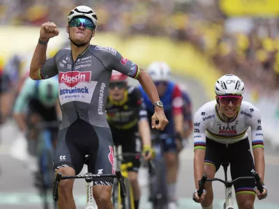 Netherlands' Mathieu van der Poel celebrates as he crosses the finish line to win the second stage of the Tour de France cycling race over 209.1 kilometers (129.9 miles) with start in Lauwin-Planque and finish in Boulogne-sur-Mer, France, Sunday, July 6, 2025. Slovenia's Tadej Pogacar finished second. (AP Photo/Mosa'ab Elshamy)