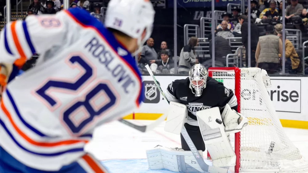 Edmonton Oilers center Jack Roslovic, left, shoots against Los Angeles Kings goaltender Anton Forsberg during the third period of an NHL hockey game Thursday, Feb. 26, 2026 in Los Angeles. (AP Photo/Ryan Sun)