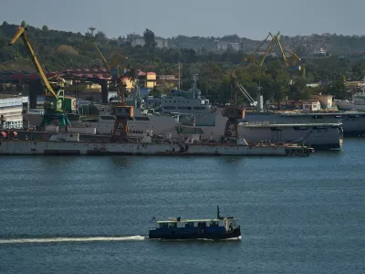 A ferry boat navigates across Havana Bay as it passes Cuban coast guard ships docked at the port as it leaves Casablanca, Cuba, Thursday, Feb. 26, 2026. (AP Photo/Ramon Espinosa)