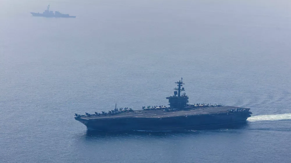 The U.S. Navy's Nimitz-class aircraft carrier USS Abraham Lincoln and Arleigh Burke-class guided-missile destroyer USS Frank E. Petersen Jr. sail during a photo exercise in the Arabian Sea, February 6, 2026. U.S. Navy/Mass Communication Specialist 1st Class Jesse Monford/Handout via REUTERS THIS IMAGE HAS BEEN SUPPLIED BY A THIRD PARTY