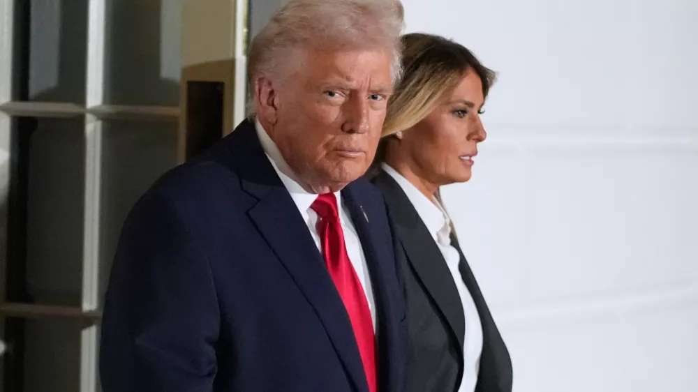 President Donald Trump and first lady Melania Trump, walk out of the White House, Tuesday, Feb. 24, 2026, to travel to the U.S. Capitol where he will deliver the State of the Union address to a joint session of Congress in the House chamber, in Washington. (AP Photo/Manuel Balce Ceneta)