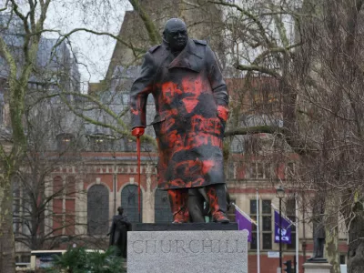 The statue of Winston Churchill in Parliament Square, which has been defaced with graffiti branding the former prime minister a "Zionist war criminal", in London, Friday Feb. 27, 2026. (Lucy North/PA via AP)