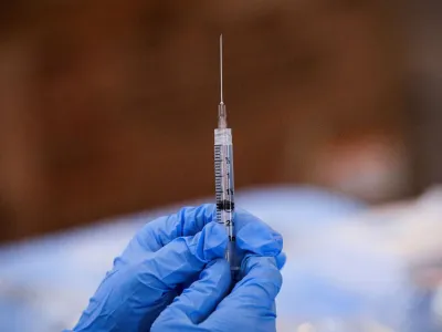 FILE PHOTO: A syringe is filled with a dose of Pfizer's coronavirus disease (COVID-19) vaccine at a pop-up community vaccination center at the Gateway World Christian Center in Valley Stream, New York, U.S., February 23, 2021. REUTERS/Brendan McDermid/File Photo