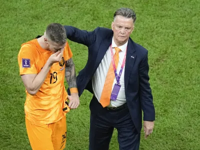 Wout Weghorst, left, is consoled by head coach Louis van Gaal of the Netherlands, at the end of the World Cup quarterfinal soccer match between the Netherlands and Argentina, at the Lusail Stadium in Lusail, Qatar, Saturday, Dec. 10, 2022. (AP Photo/Ariel Schalit)