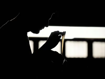 A worker puts glue on shoe soles in a shoe making factory, as small and medium-sized businesses struggle amid rising inflation, on the outskirts of Buenos Aires, Argentina, May 4, 2023. REUTERS/Mariana Nedelcu