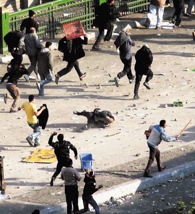 Ostanki politične  policije in civilno  oblečeni pristaši  stranke Hosnija  Mubaraka (levo)  so odganjali ljudi  s prizorišča...