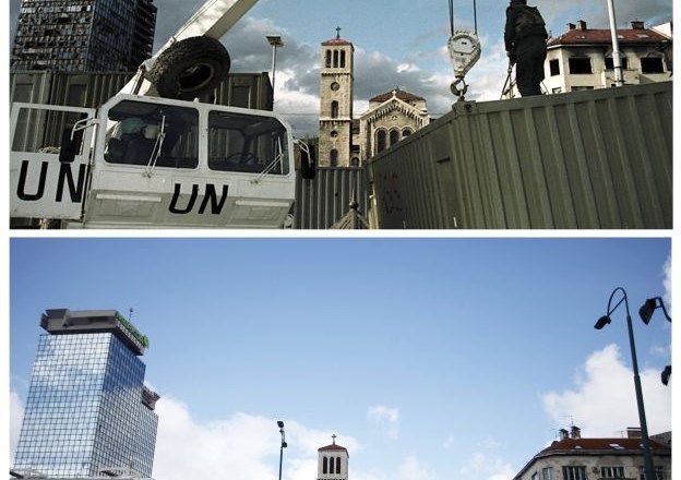 Mirovni delavec ZN stoji ob gradbišču zatočišča pred poškodovanimi stolpnicami UNITIC in pravoslavno cekrvijo v Sarajevu....