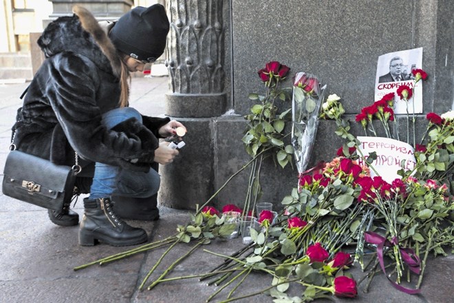Pred sedežem ruskega zunanjega ministrstva so ljudje včeraj polagali cvetje v poklon umorjenemu veleposlaniku Andreju...
