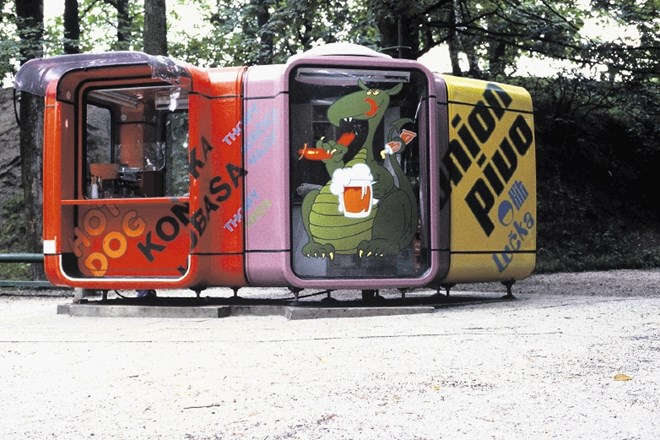 Kiosk K67 (kompozicija 3 elementov), okrepčevalnica hitre prehrane Lačni zmaj iz leta 1979, je stal na ploščadi parkirišča...