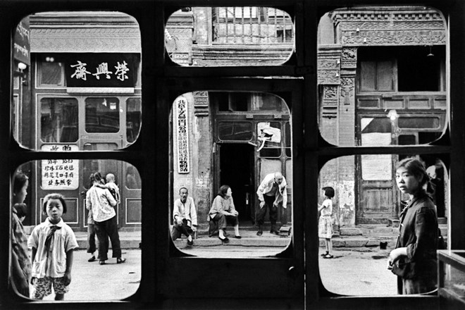 Marc Riboud, Peking, 1965: Ulica Da Sha La v starem delu Pekinga – pogled skozi okno antikvariata. Ljudje pridejo sem prodat...