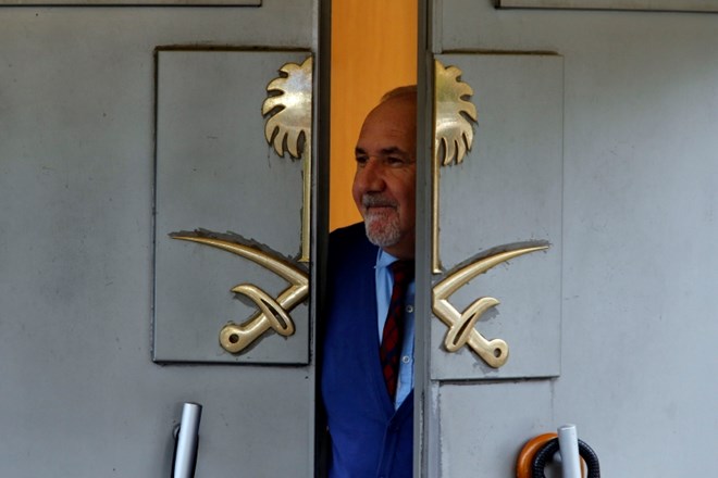 Varnostnik pogleduje skozi vrata konzulata Savdske Arabije v Carigradu.