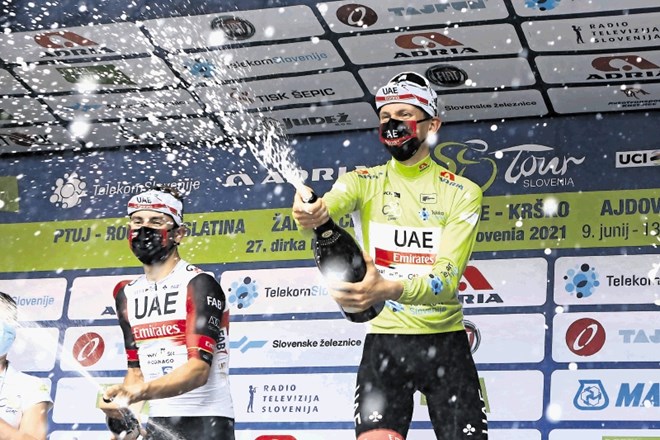 Slovenski kolesar Tadej Pogačar (UAE Emirates, desno) se je včeraj na cilju v Novem mestu takole veselil svoje premierne...