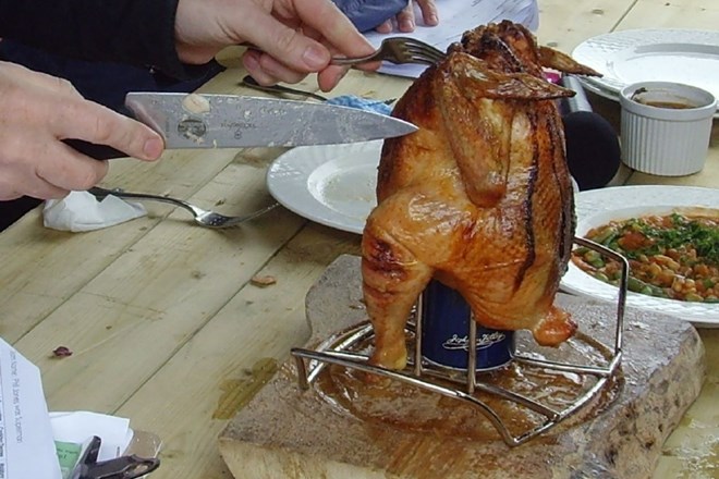 Ameriški način pečenja celega piščanca ki ga nasadimo na odprto polno pločevinko piva in postavljenega pokonci (obstajajo...
