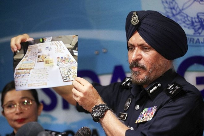 Direktor preiskovalnega urada za gospodarski kriminal Amar Singh je med tiskovno konferenco pokazal sliko zaplenjenih...