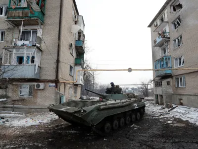 Service members of pro-Russian troops in uniforms without insignia drive an armoured vehicle with the letters "Z" painted on it in a residential area of the separatist-controlled town of Volnovakha during Ukraine-Russia conflict in the Donetsk region, Ukraine March 11, 2022. REUTERS/Alexander Ermochenko