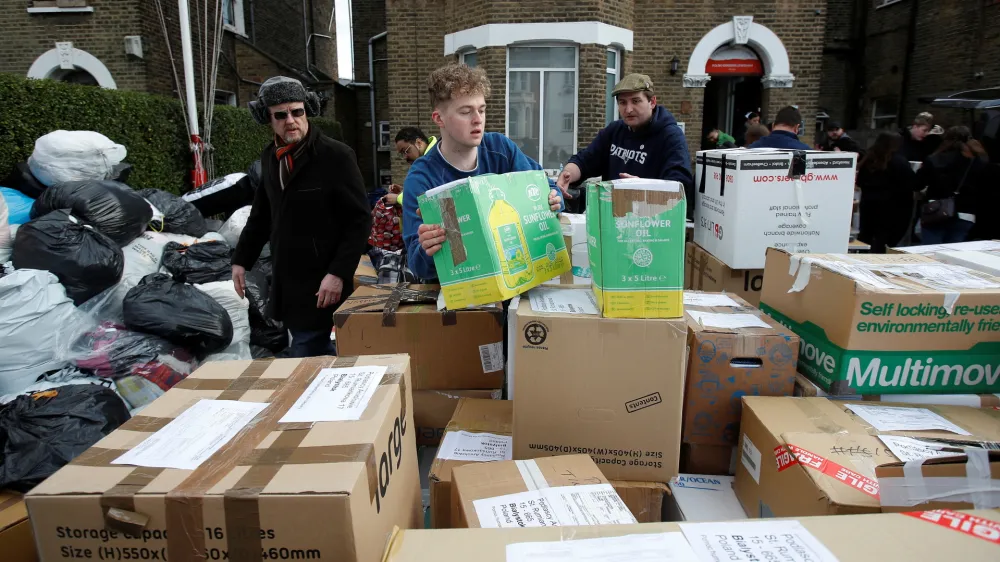 Volunteers prepare boxes of donated food, clothing and other essential items, to be sent to Ukrainian refugees in Poland, following Russia's invasion of Ukraine, at the Lewisham Polish Centre, in London, Britain, March 6, 2022. REUTERS/Peter Nicholls? - RC22XS9I9PJ1