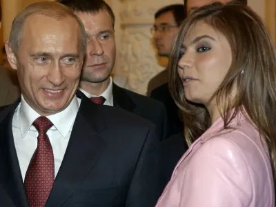President Vladimir Putin, left, speaks with gymnast Alina Kabayeva as he hosts Russia's Olympic athletes at a Kremlin banquet in Moscow, Thursday, Nov. 4, 2004. Vladimir Putin on Thursday congratulated the country's Olympic team on their strong showing in Athens and stressed the importance of a healthy lifestyle. (AP Photo/ITAR-TASS, Presidential Press Service)