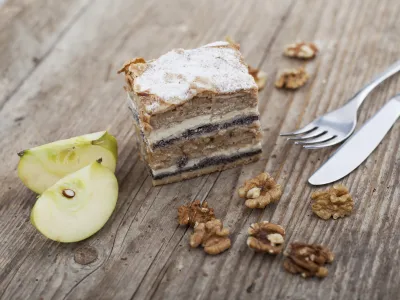 Prekmurska hibanica over mura moving layered cake on wooden surface